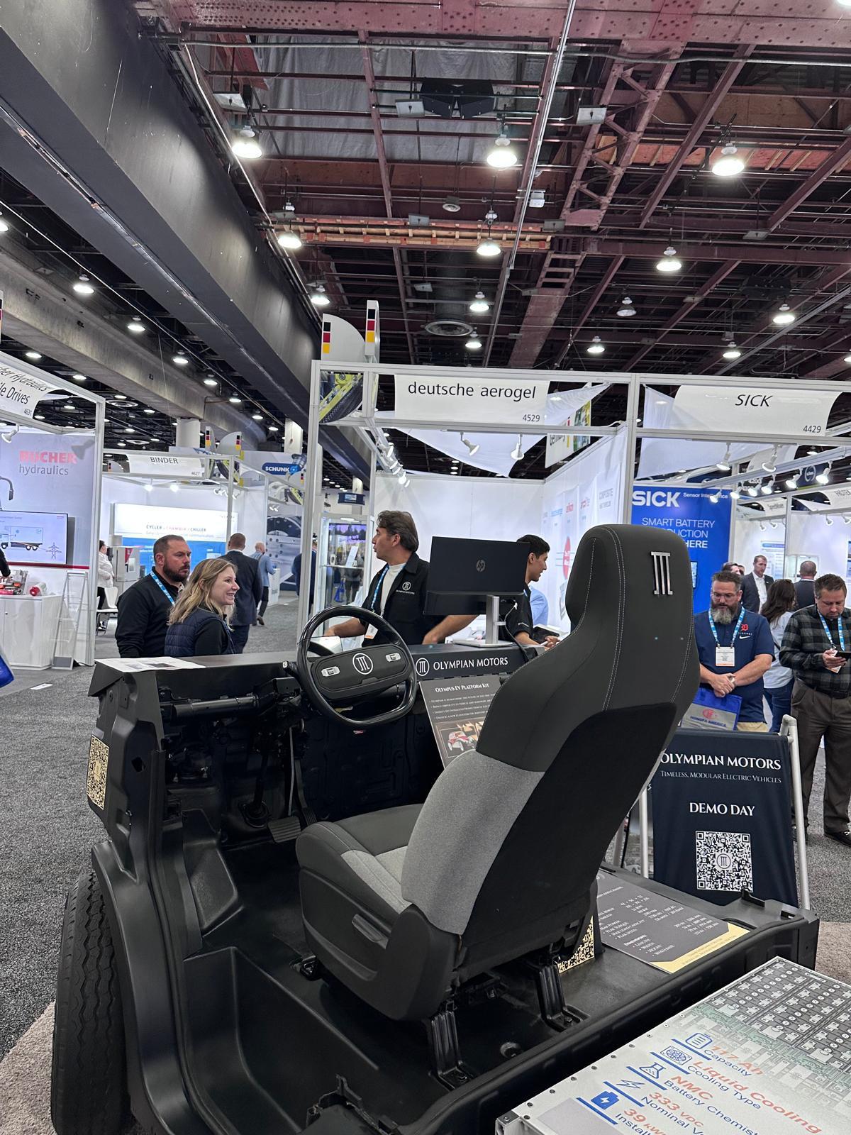 Guest exploring an Olympian Motors vehicle at the Detroit Battery Show